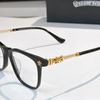 Black eyeglasses close-up with gold-tone temple accents and clear lenses