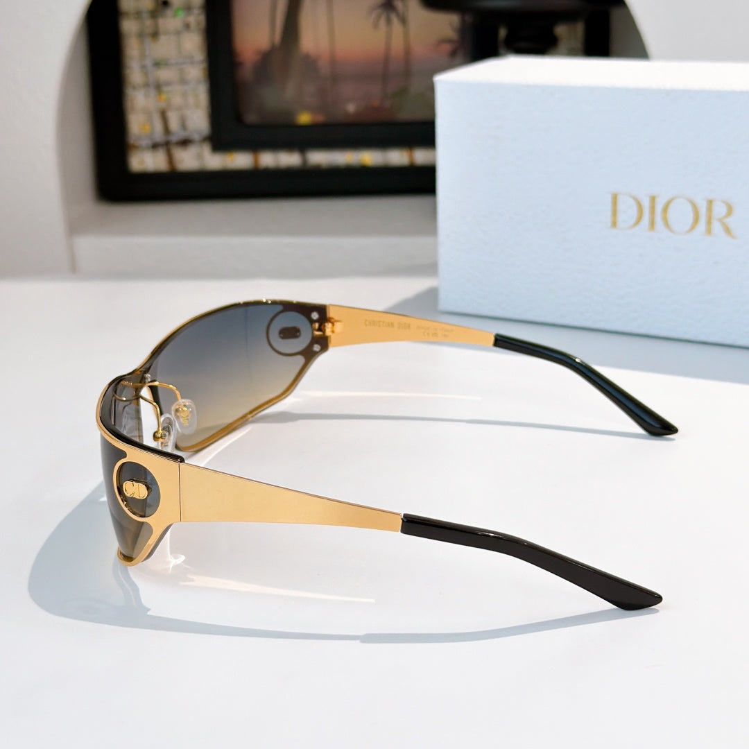 Black-tinted sunglasses with gold frame and dark temples.