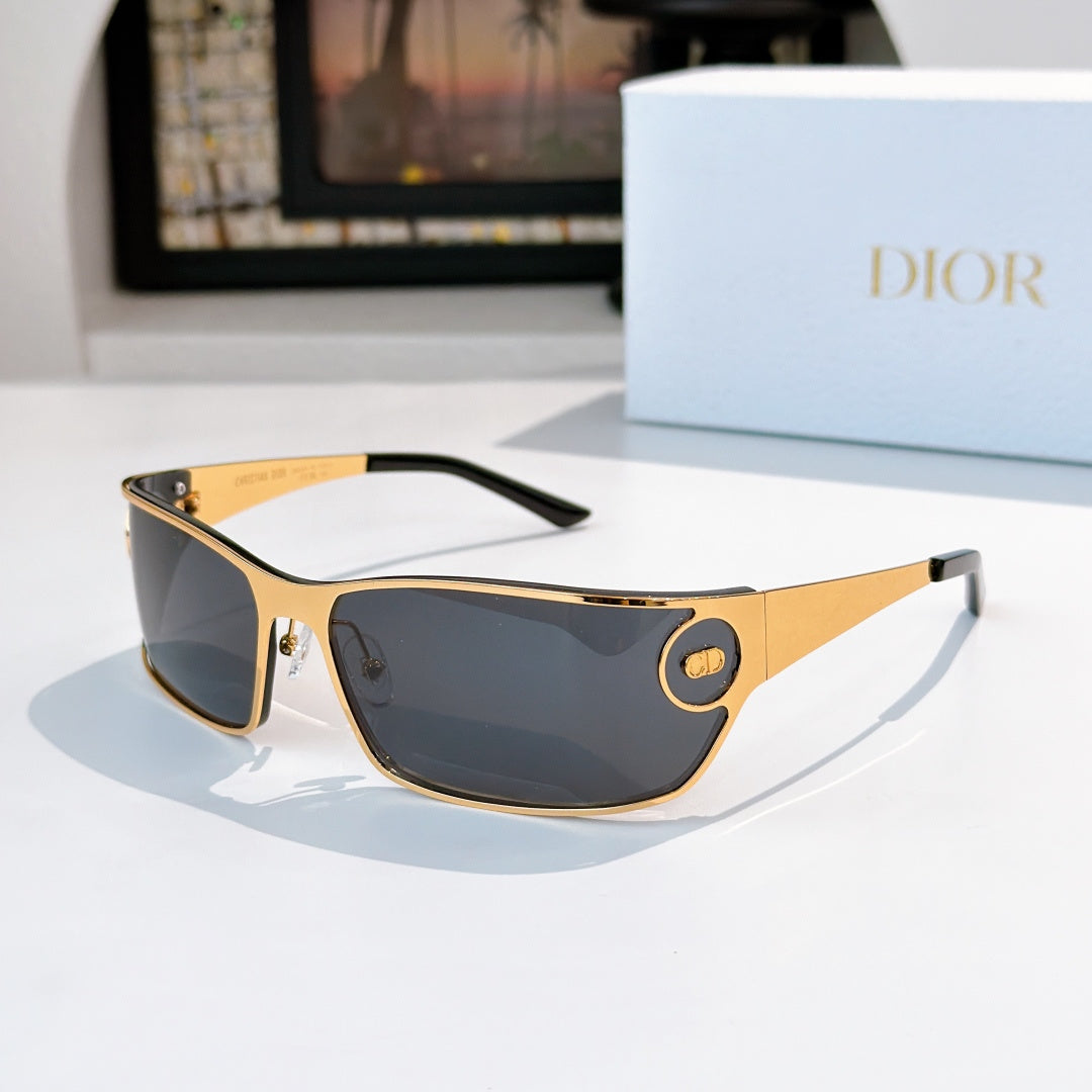 Dark-tinted sunglasses with gold frame and black temple tips.