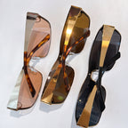 Three sunglasses with tinted lenses in tortoise, gold, and black.
