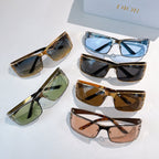 Assorted sunglasses with tinted lenses and gold frames arranged together.