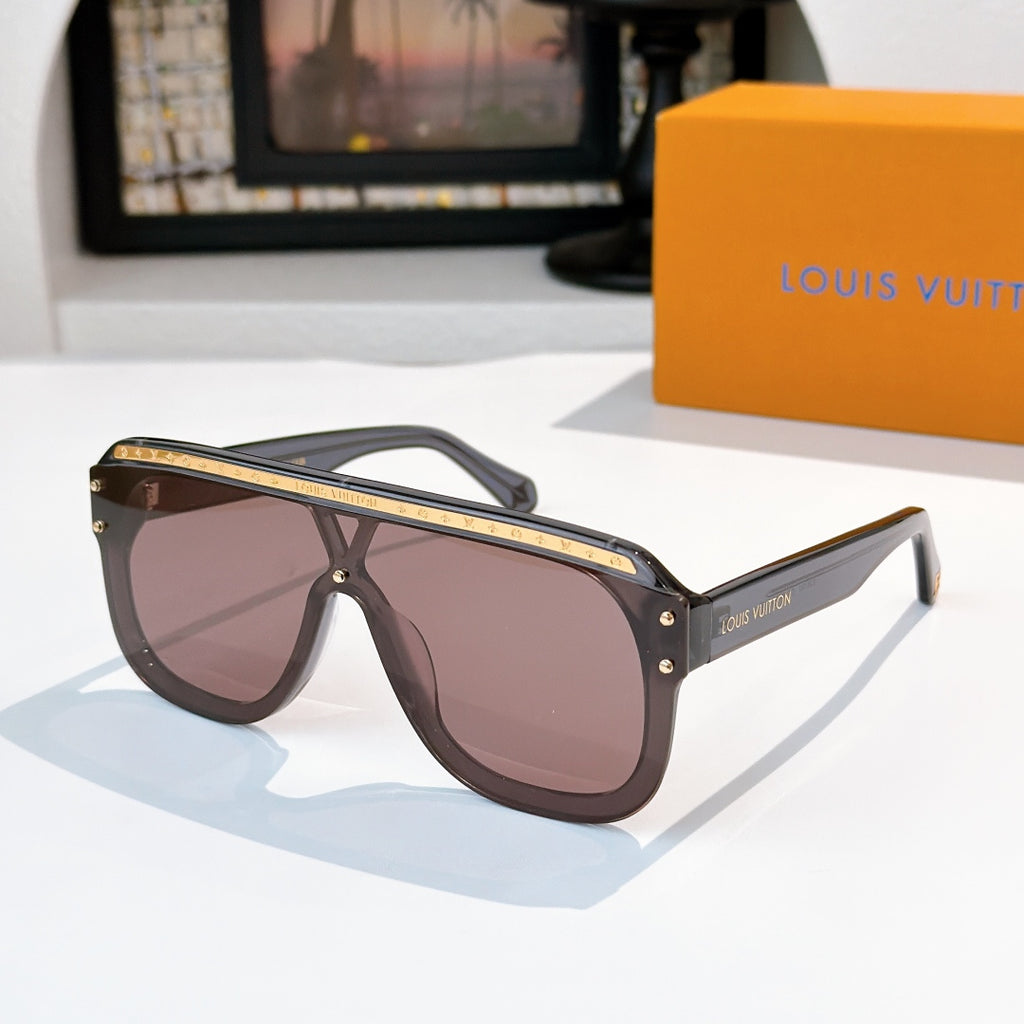 Sunglasses with dark brown frames and brown tinted lenses, gold-tone trim and stud accents.