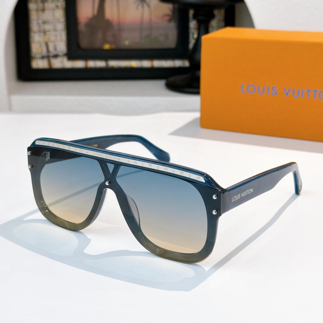 Sunglasses with teal-blue frames and light blue tinted lenses, gold-tone trim.