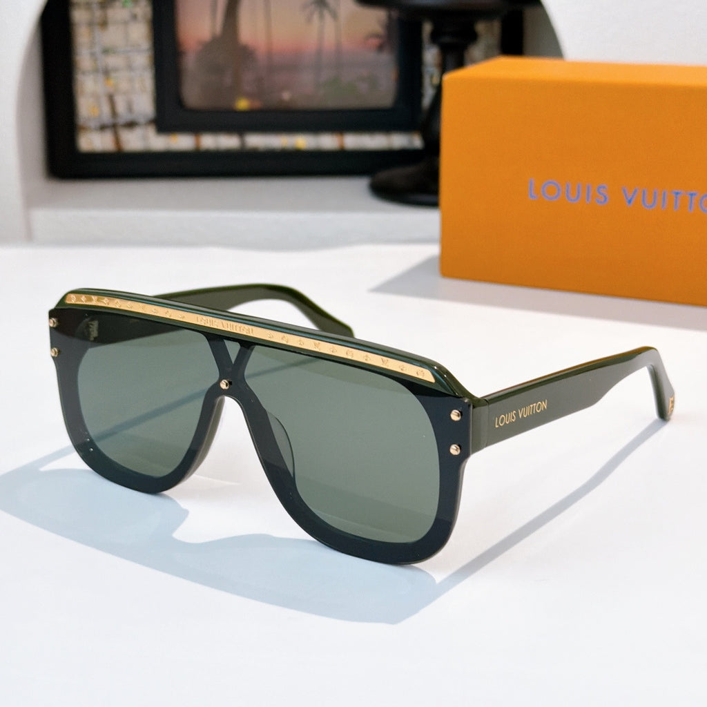 Sunglasses with dark green frames and dark tinted lenses, gold-tone trim and hinge details.