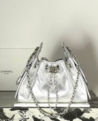 Silver quilted drawstring handbag with chain handles and metal ring hardware