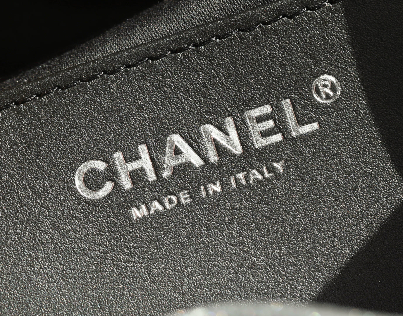 CHANEL leather label detail with "MADE IN ITALY" text and round logo