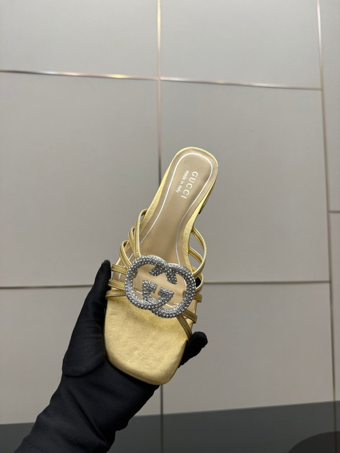 Gucci gold slide sandals with jeweled GG logo strap detail