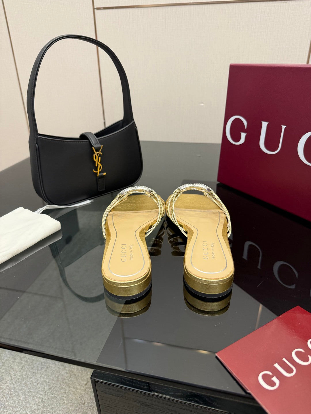Gucci gold slide sandals with jeweled GG logo, side view