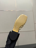 Gucci gold slide sandals with curved toe strap detail, low heel
