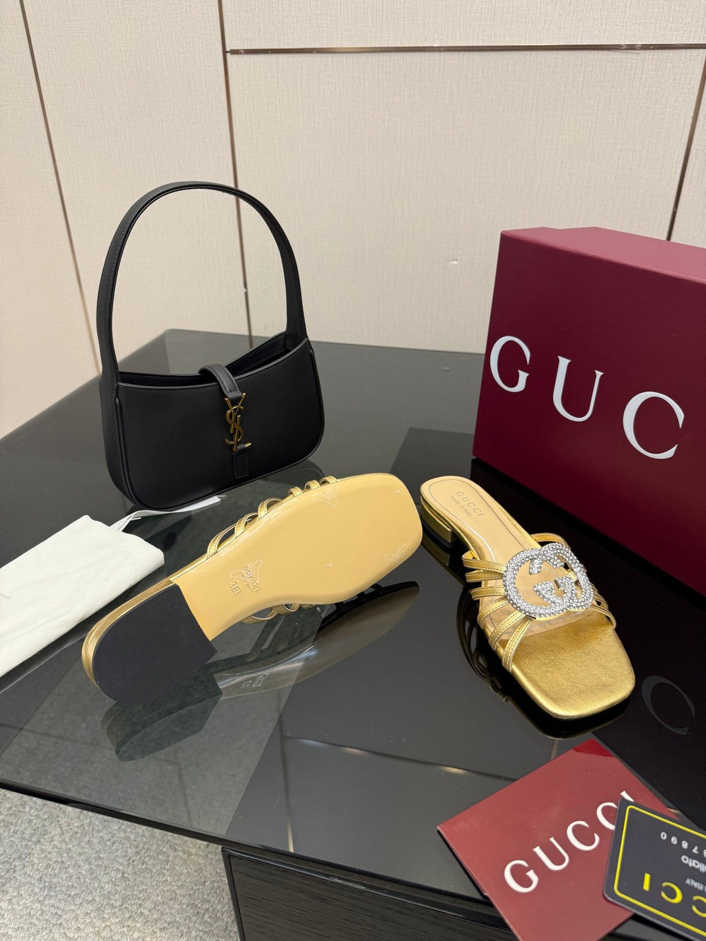 Gucci gold slide sandals with jeweled GG logo ornament and low heel