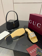 Gucci gold slide sandals with jeweled GG logo ornament and low heel