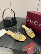 Gucci gold mule slide sandals with jeweled GG logo, low block heel