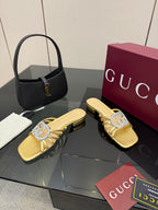 Gucci gold slide sandals with jeweled GG logo and low stacked heel