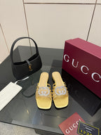 Gucci gold slide sandals with jeweled GG logo, low stacked heel