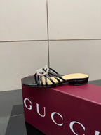 Gucci ladies black mule slide shoe on magenta box with rhinestone GG emblem