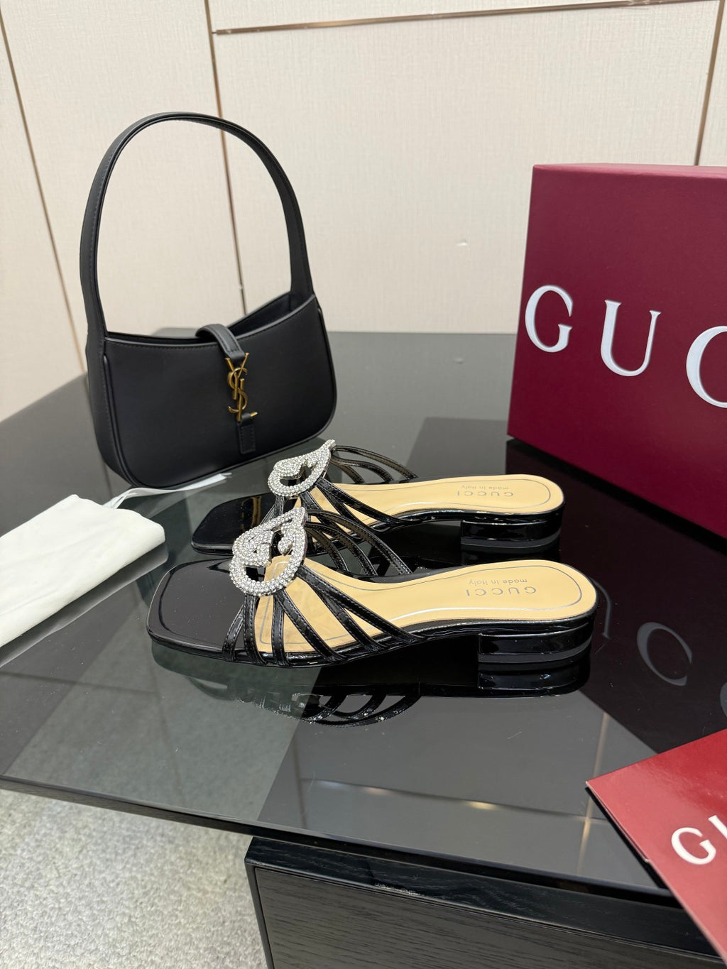 Gucci ladies black mule sandals with rhinestone GG buckle and braided strap detail