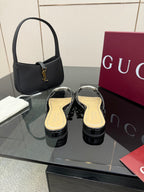 Gucci ladies black patent mule slides with gold footbed and rhinestone GG emblem