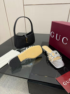 Gucci ladies silver jeweled slide sandals, side view with crystal bow and low sole