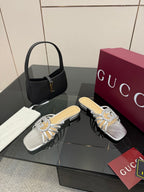 Gucci ladies jeweled slide sandals, silver upper with knot-bow ornament and low heel