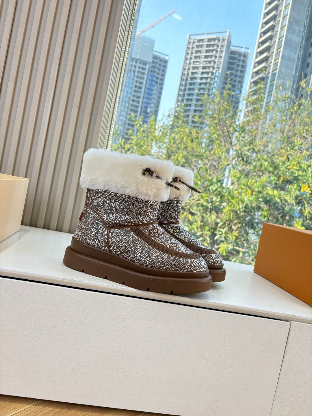Brown glitter ankle boots with white shearling cuff and side strap detail