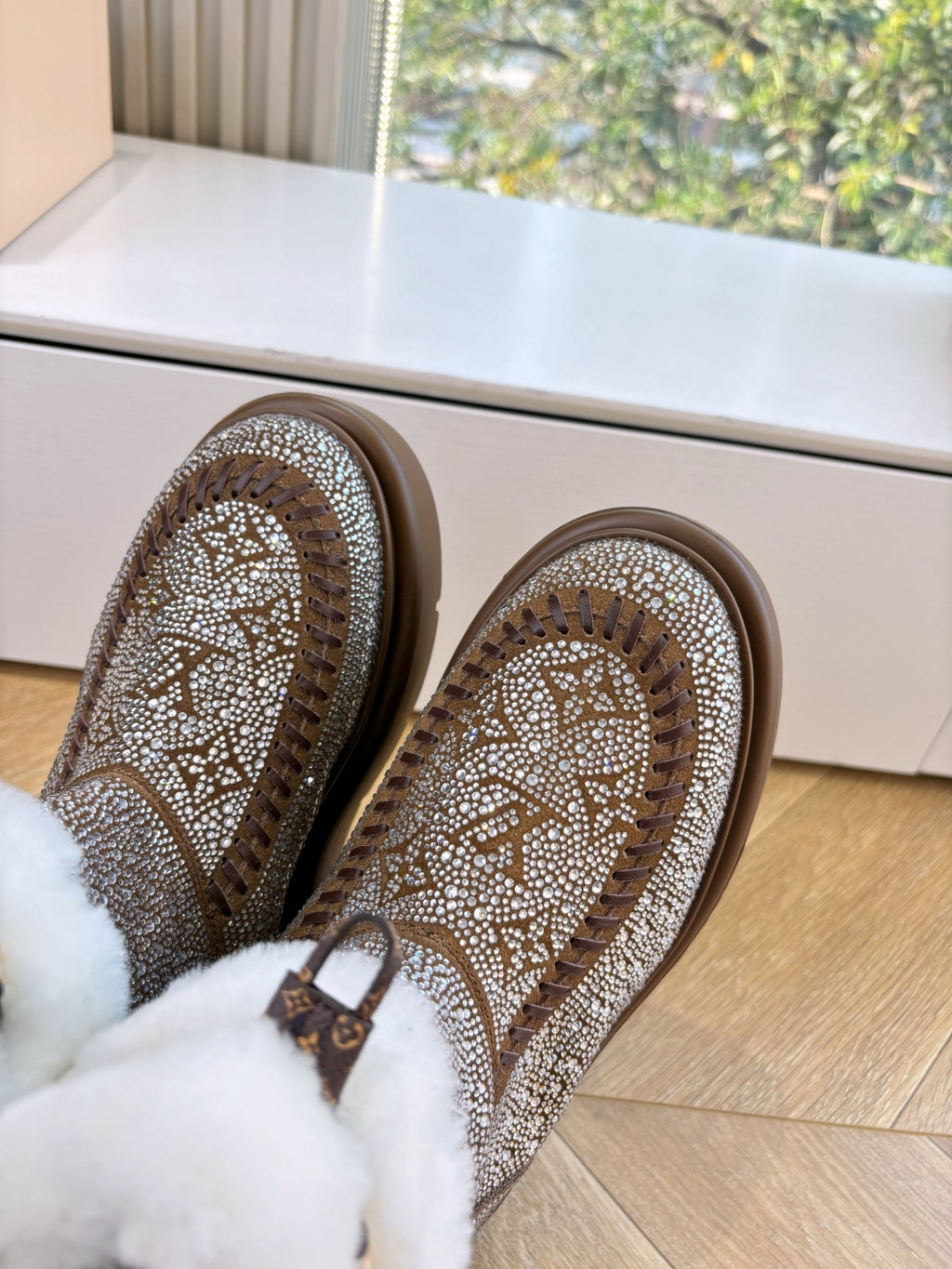 Brown glitter slip-on boots with textured uppers and white fur cuff at opening