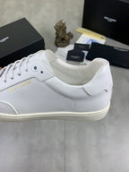 White lace-up sneaker with curved collar, perforated upper, beige rubber sole