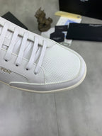 White perforated sneaker toe with lace-up eyelets and rubber midsole