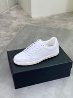 White lace-up sneakers with smooth upper and low-profile rubber sole