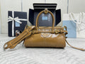 Tan leather tote bag with gold hardware, top handle, and detachable shoulder strap