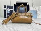 Tan leather tote bag with gold hardware, top handle, and detachable shoulder strap