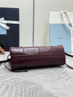 Burgundy leather shoulder handbag with flap closure and crossbody strap.