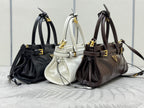 Prada mini handbags trio in black, white, and dark brown with top handles