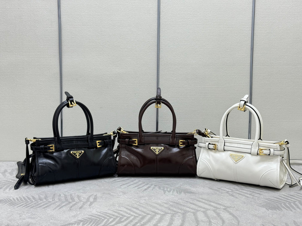 Prada handbags in black, dark brown, and white with top handles and shoulder straps