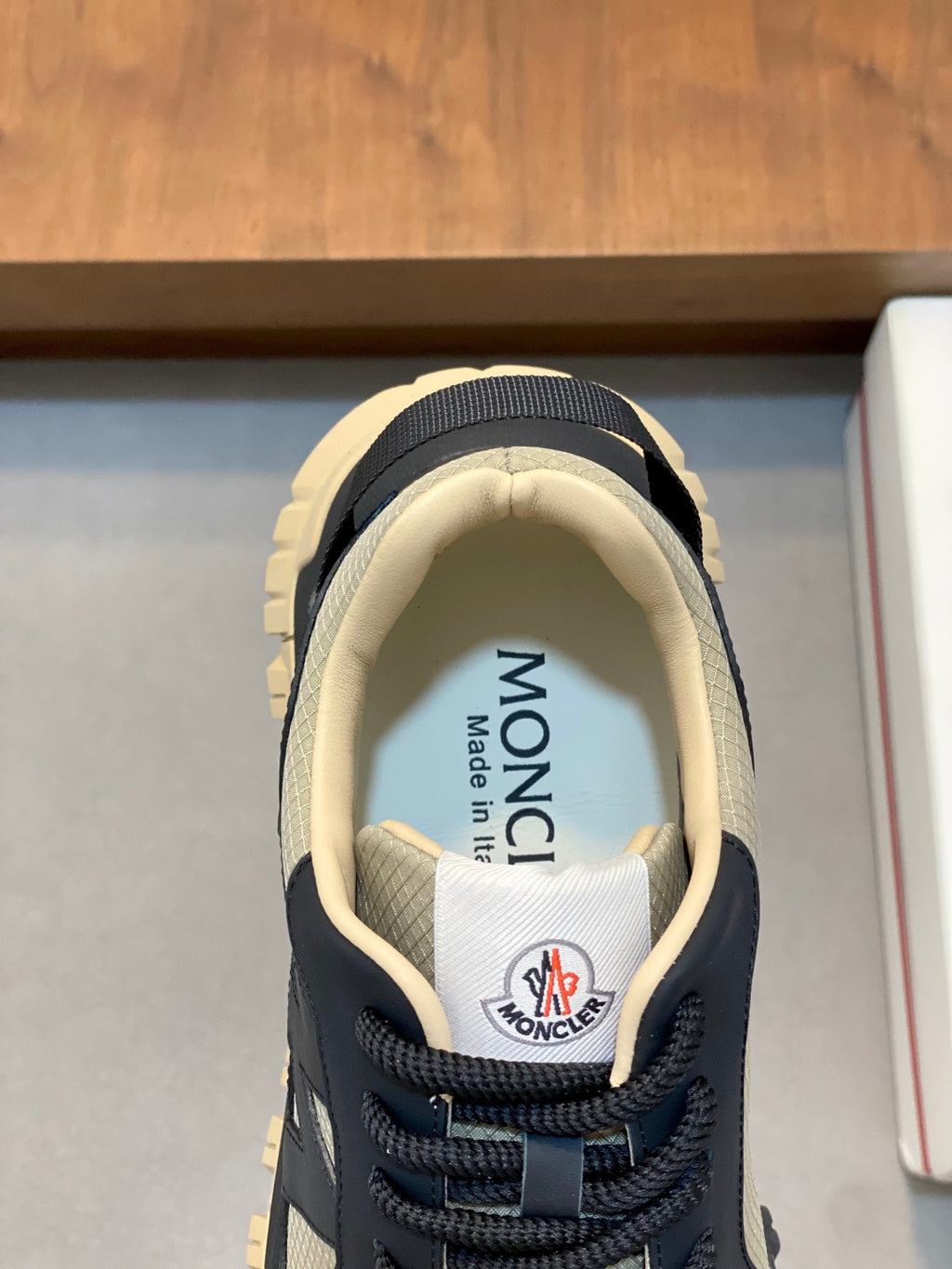 Moncler sneaker tongue and lace area with MONCLER logo on the insole