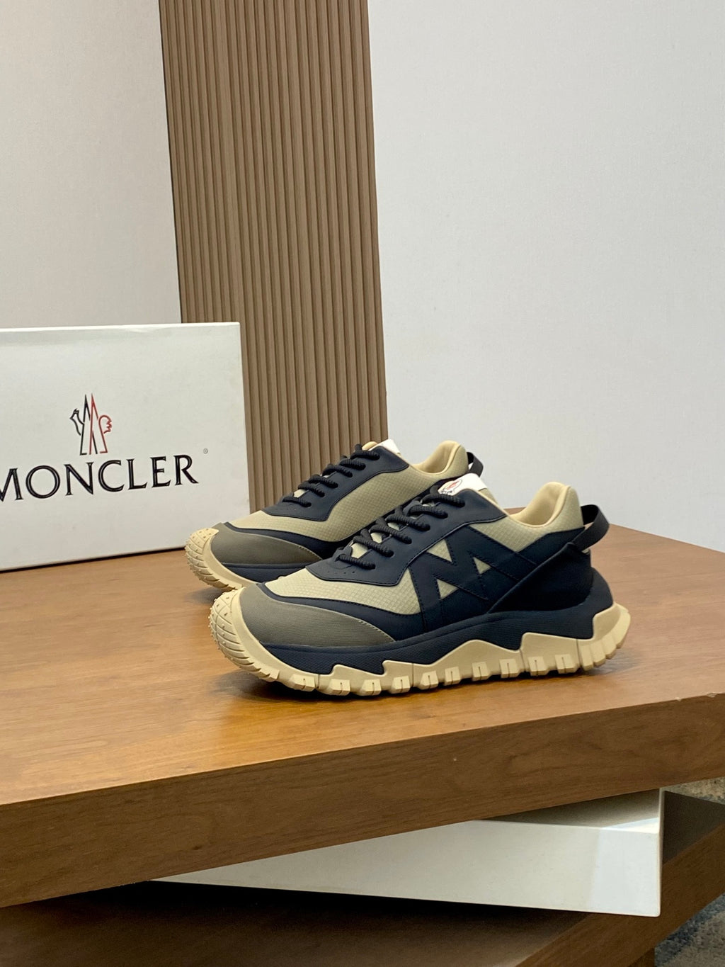 Moncler low-top sneakers with dark navy and beige color blocking and thick tread sole