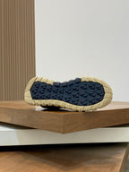 Moncler sneaker outsole view with dark tread and beige edge cushioning