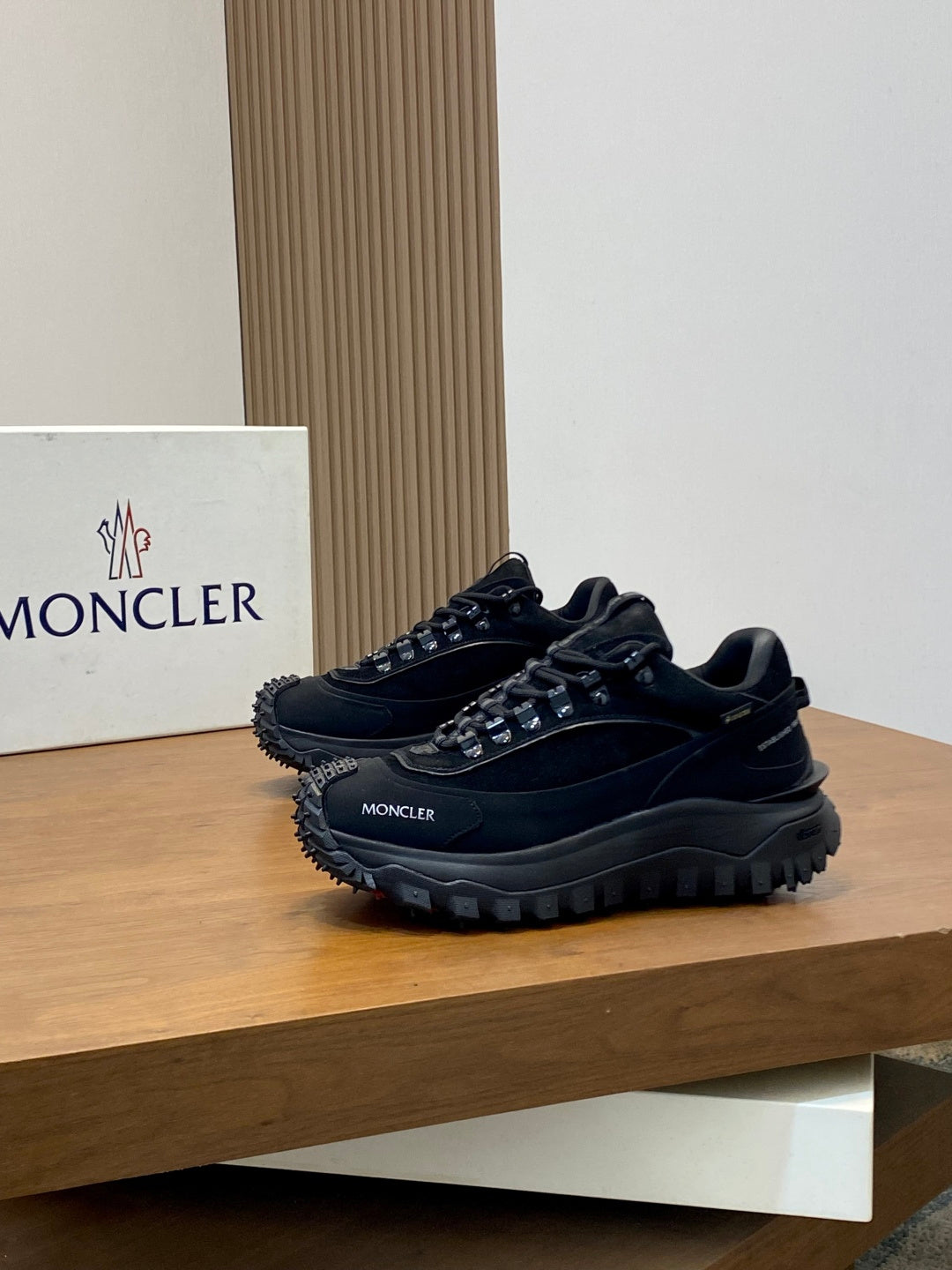 Moncler luxury lace-up shoes with dark mesh and logo on side; thick lug outsole