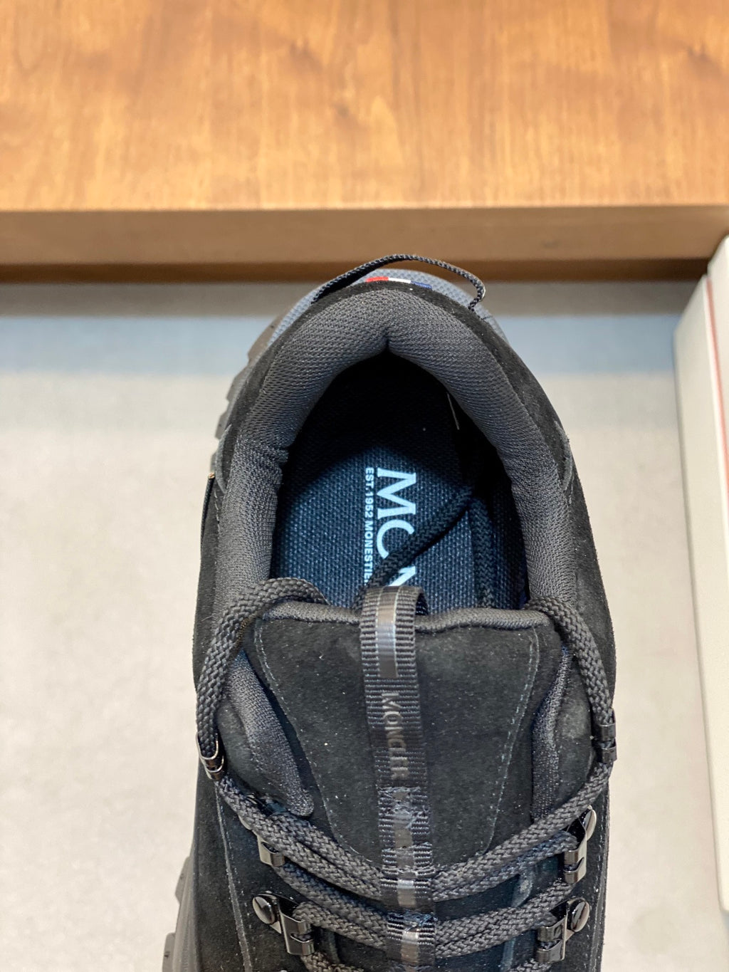 Moncler luxury shoe tongue lining close-up with fabric and branding detail