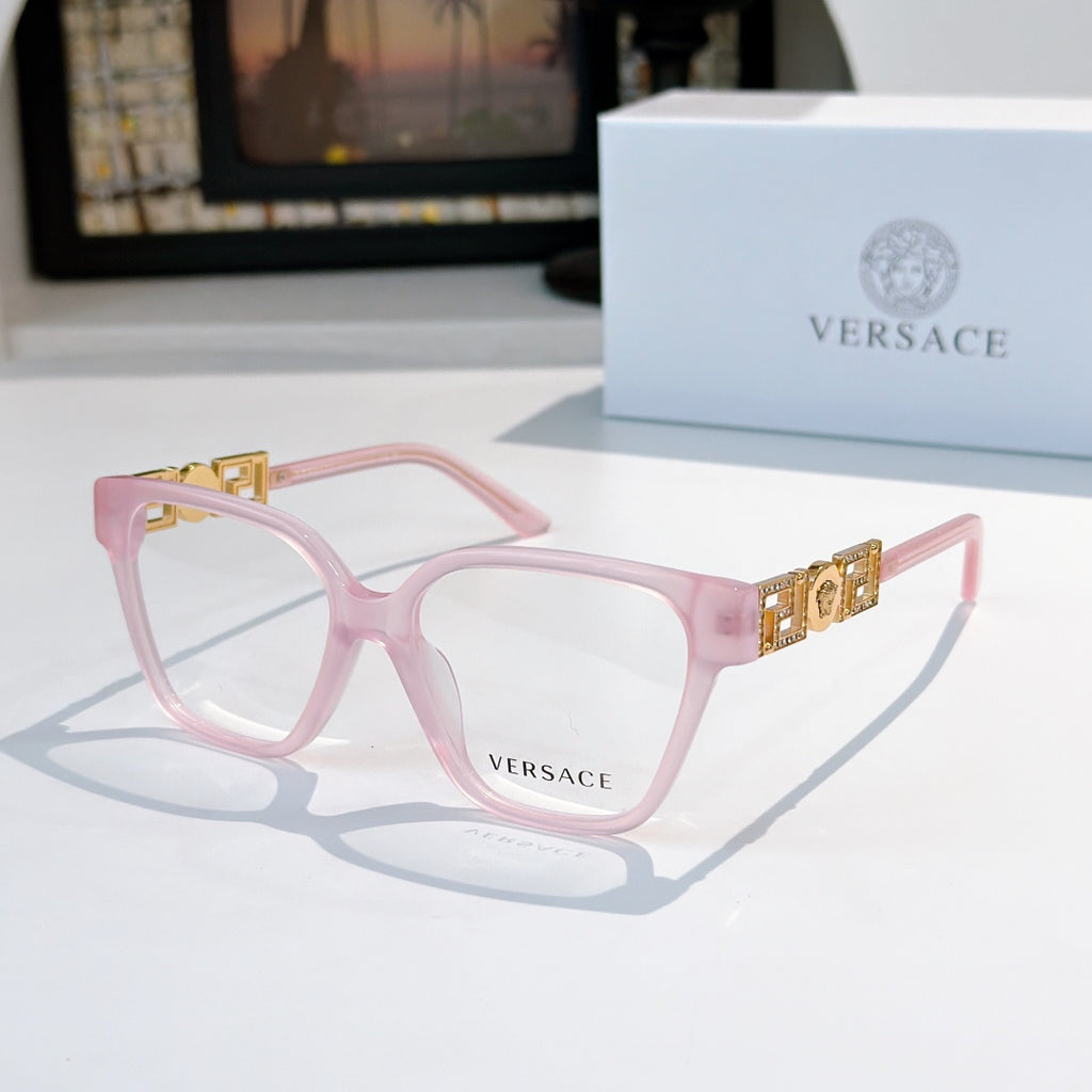 Pink square eyeglasses with gold temple logo detail and clear lenses