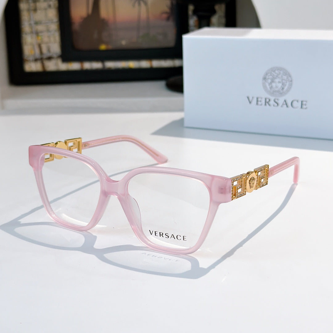 Pink square eyeglasses with gold temple logo detail and clear lenses