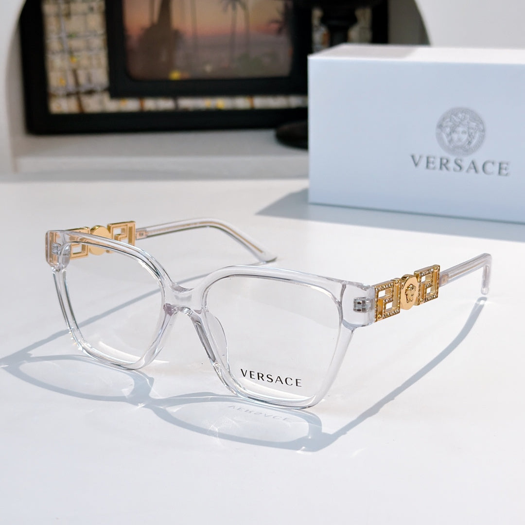 Clear-lens eyeglasses with light metal frames and gold logo temple detail
