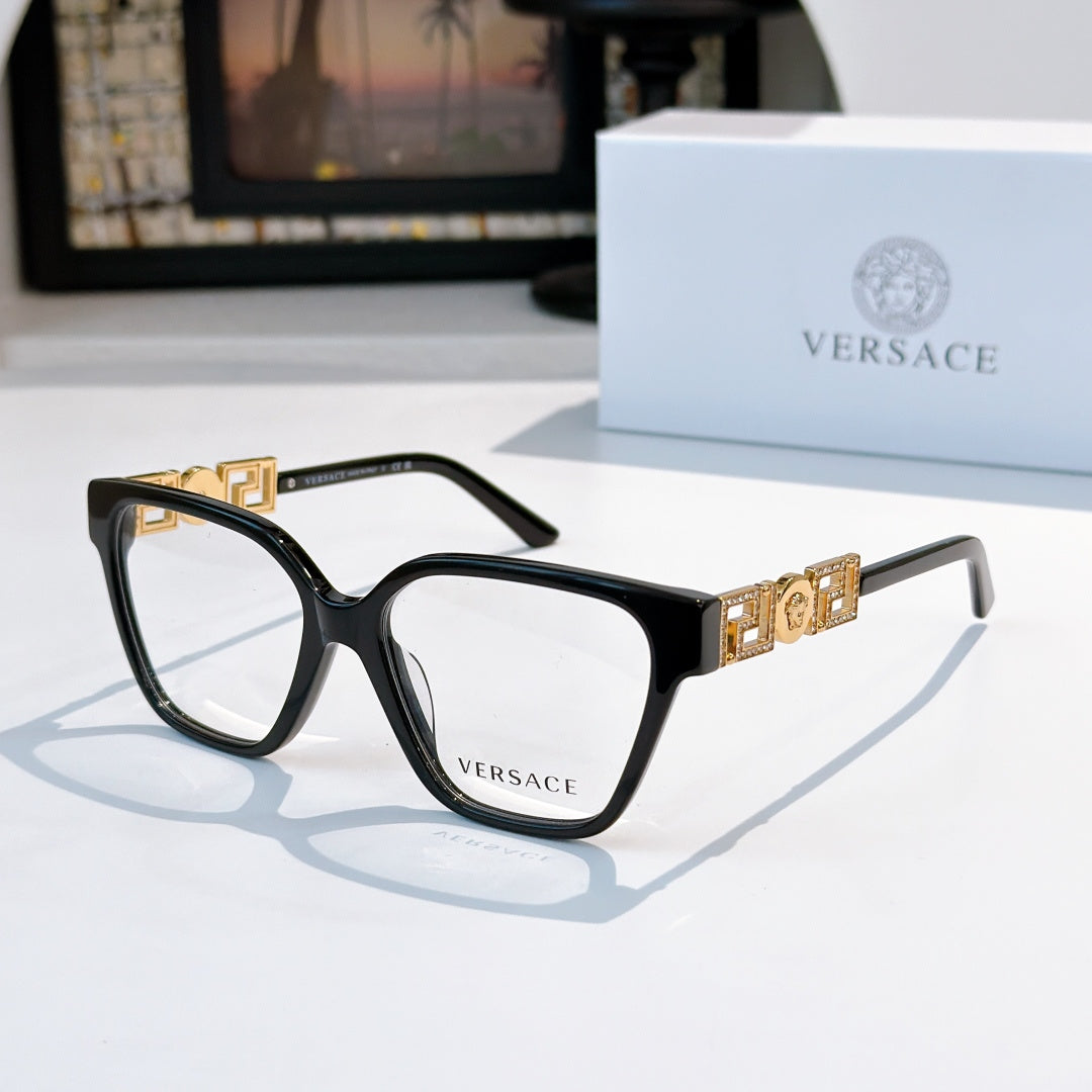 Black square eyeglasses with gold temple logo detail and clear lenses