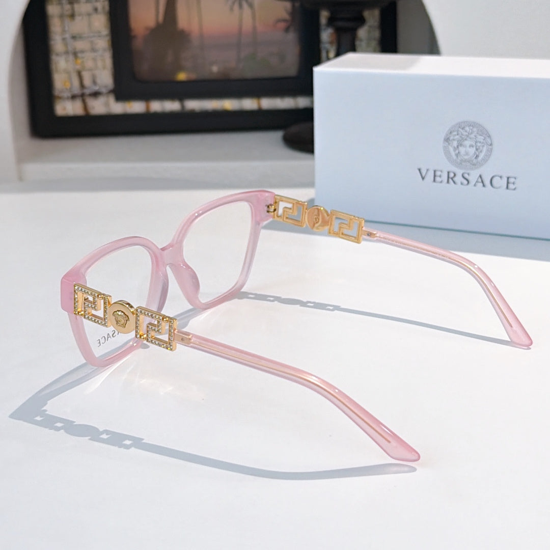 Pink eyeglasses with gold patterned temple detailing and clear lenses