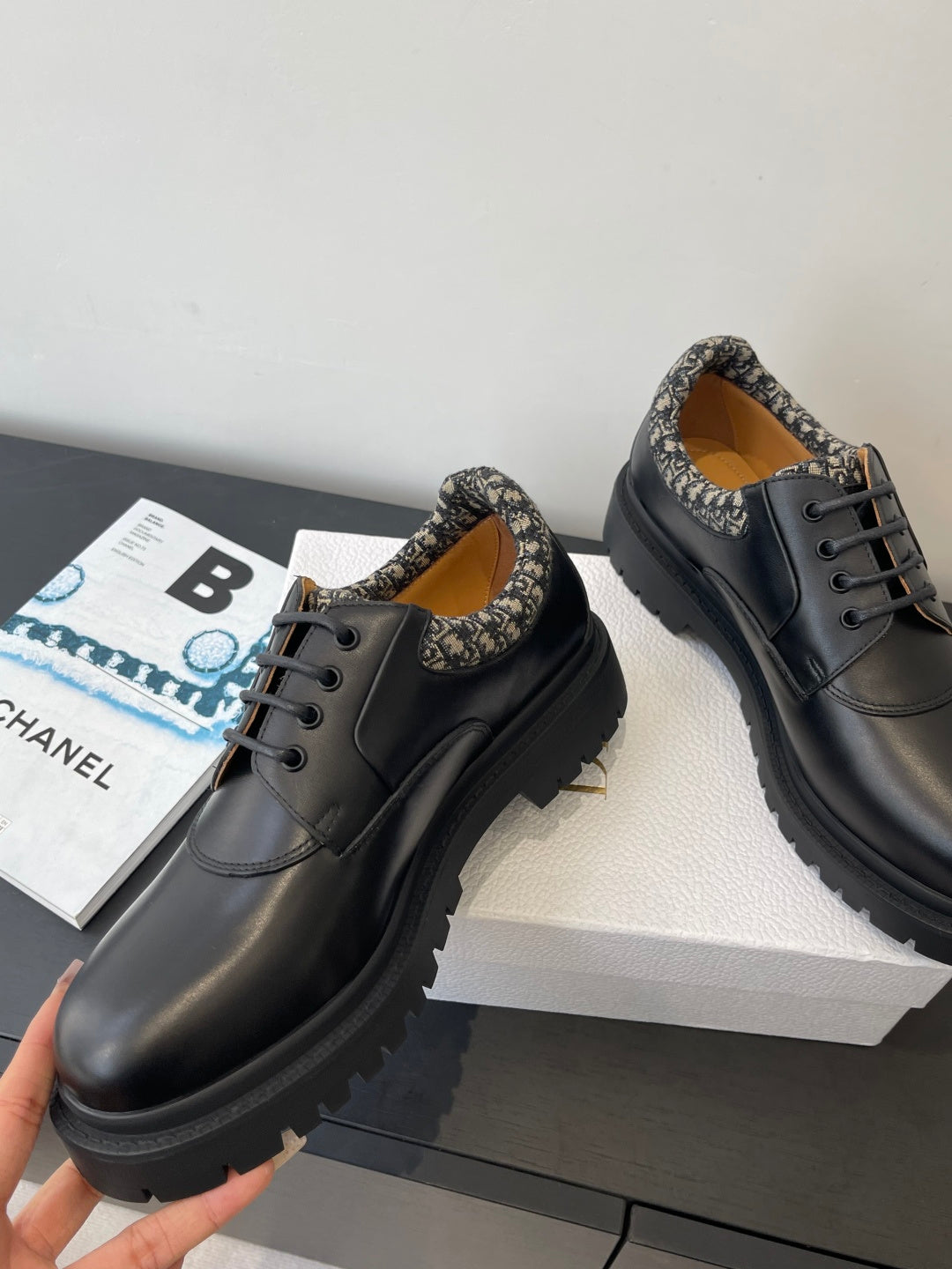 Dior unisex lace-up shoes with dark leather uppers and patterned collar, angled view