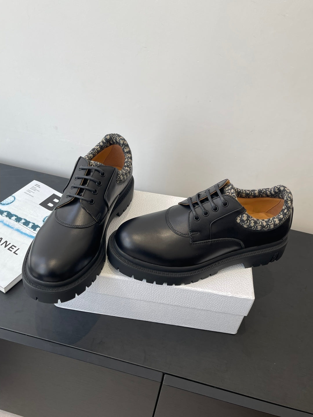 Dior unisex lace-up shoes with dark leather uppers and patterned collar, angled side view