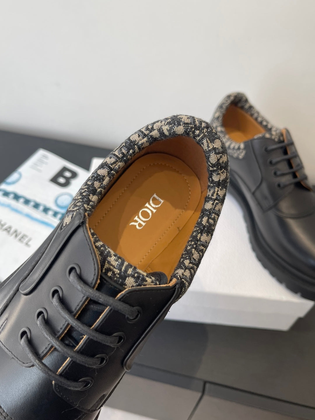 Dior lace-up shoes with patterned-trim collar and tan insole, close-up view
