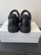 Dior unisex shoes, rear view with dark leather back panels and thick platform sole