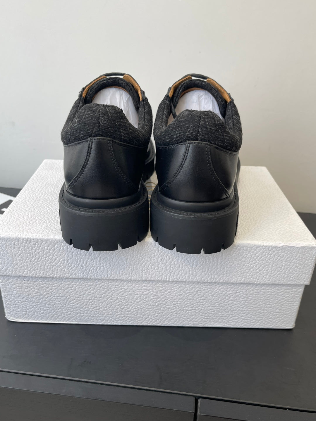 Dior unisex shoes, rear view with dark leather back panels and thick platform sole