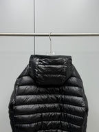 Long Moncler puffer jacket back view, black with hood and horizontal quilted panels