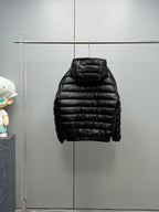 Long Moncler puffer jacket, black side view with hood and quilted body